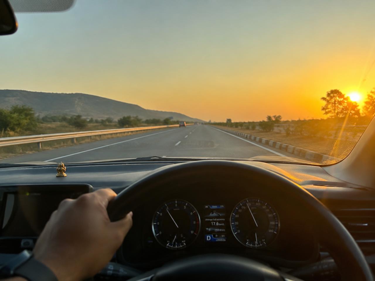 Driver at the wheel on an Indian national highway at golden hour